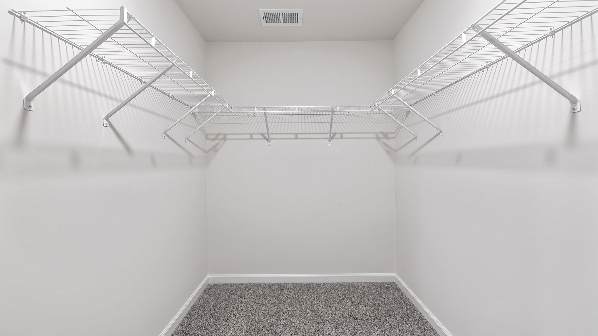 Primary bedroom walk-in closet with shelving