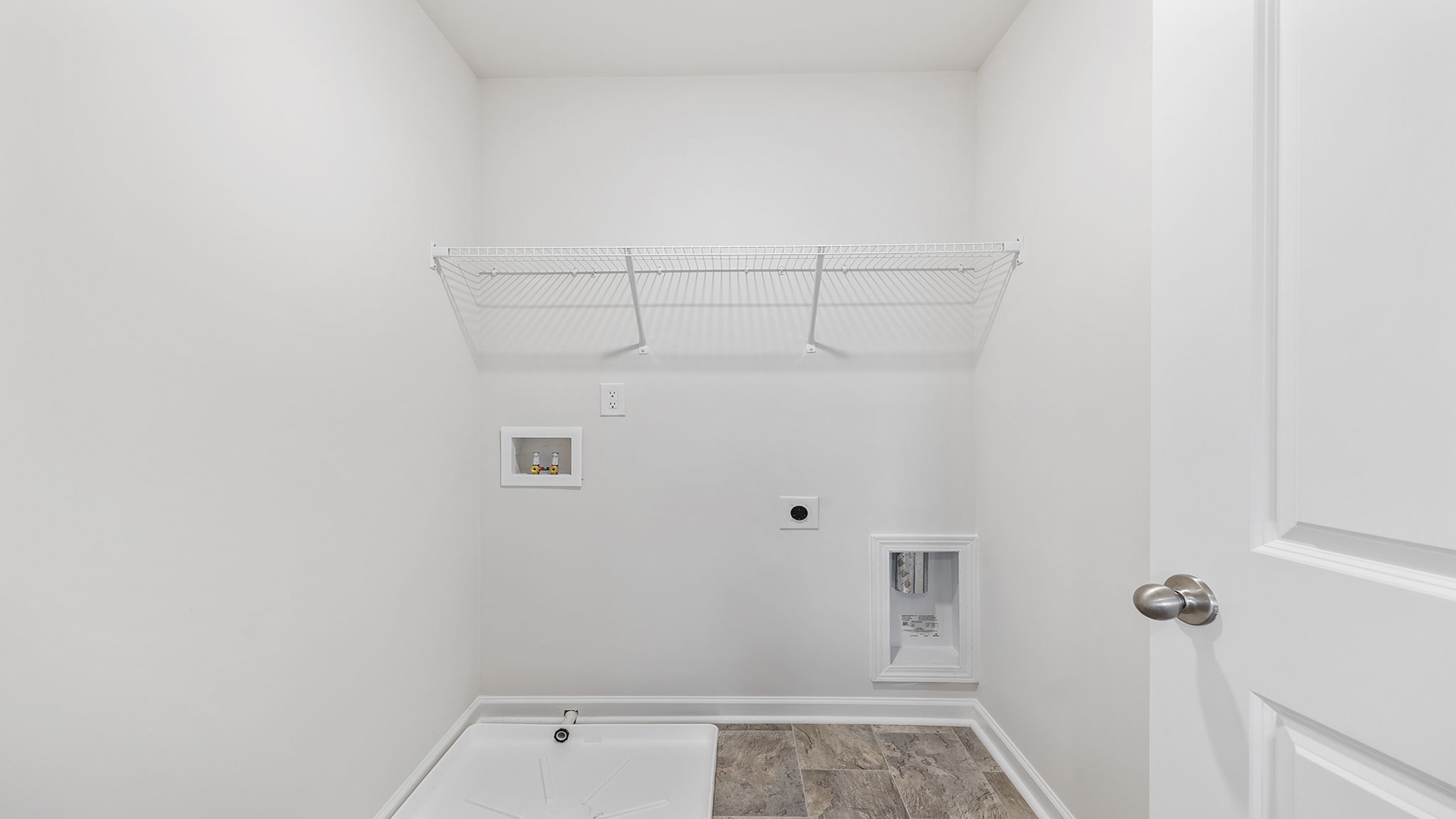 Walk in laundry room with shelving