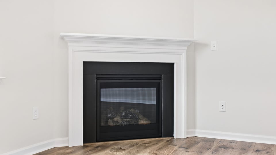 Living room with window and fireplace.