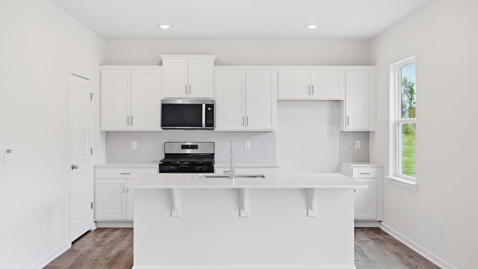 Kitchen with island and cabinets.