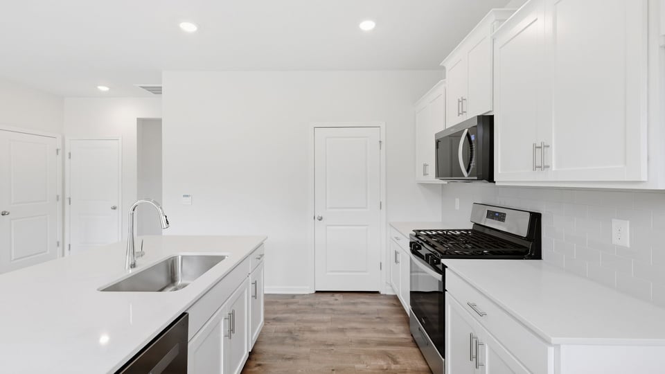 Kitchen with island and cabinets.