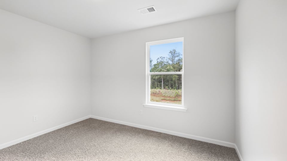Bedroom with carpet and windows.