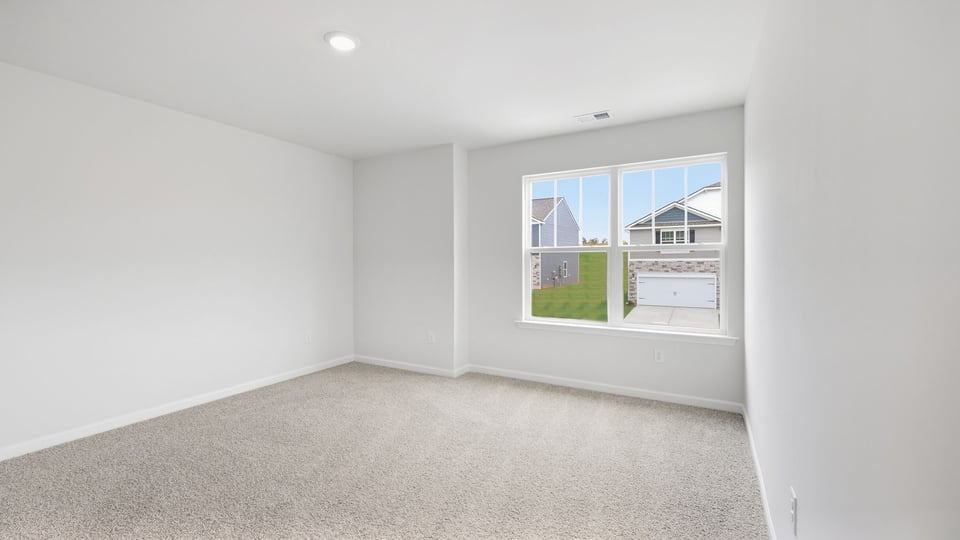 Bedroom with carpet and windows.