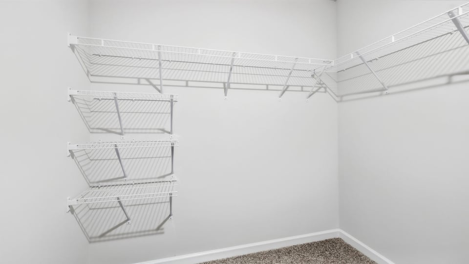 Primary closet with shelf.