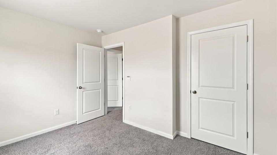 Bedroom with window and carpet.