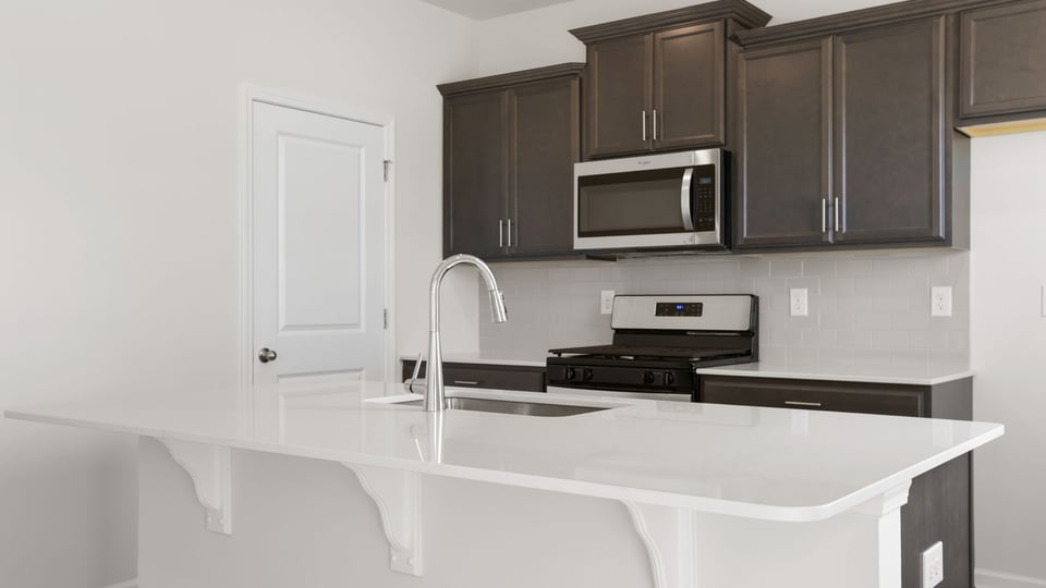 Kitchen with island and cabinets.