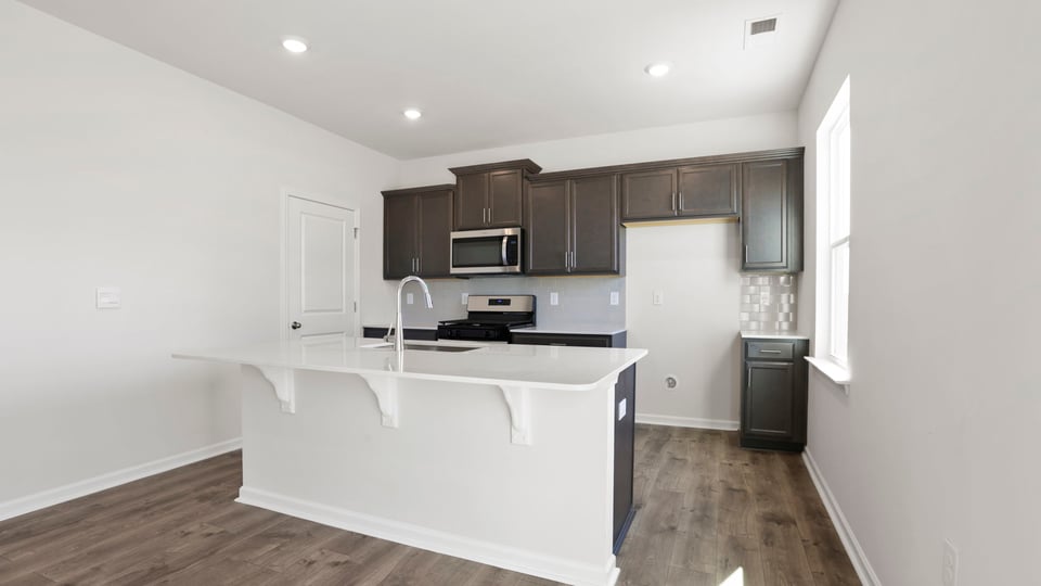 Kitchen with island and cabinets.