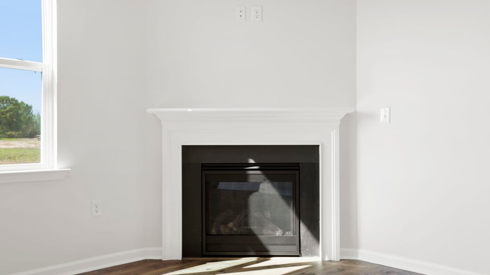 Living room with windows and fireplace.