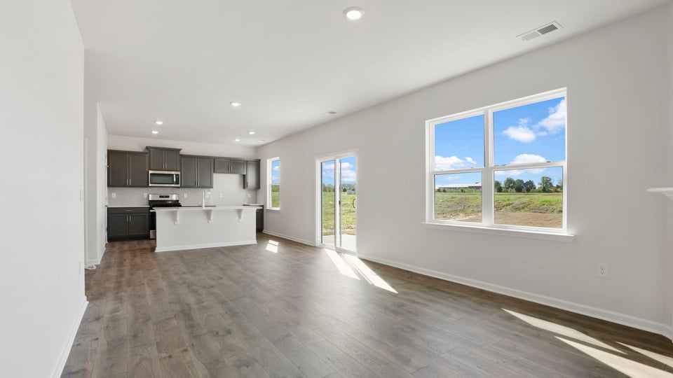 Living room with windows and fireplace.