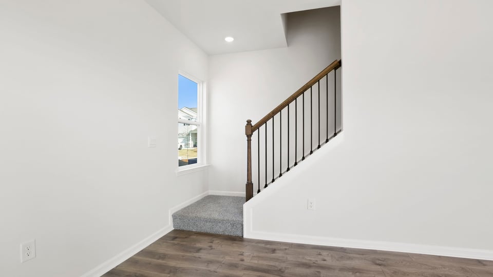 Stairs to second level with carpet.