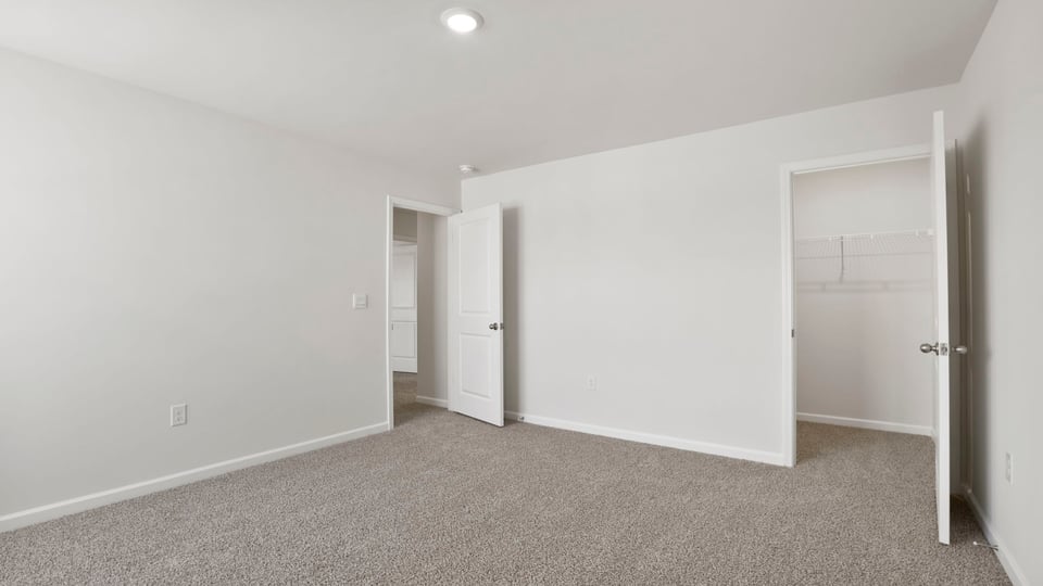 Bedroom with carpet and windows.