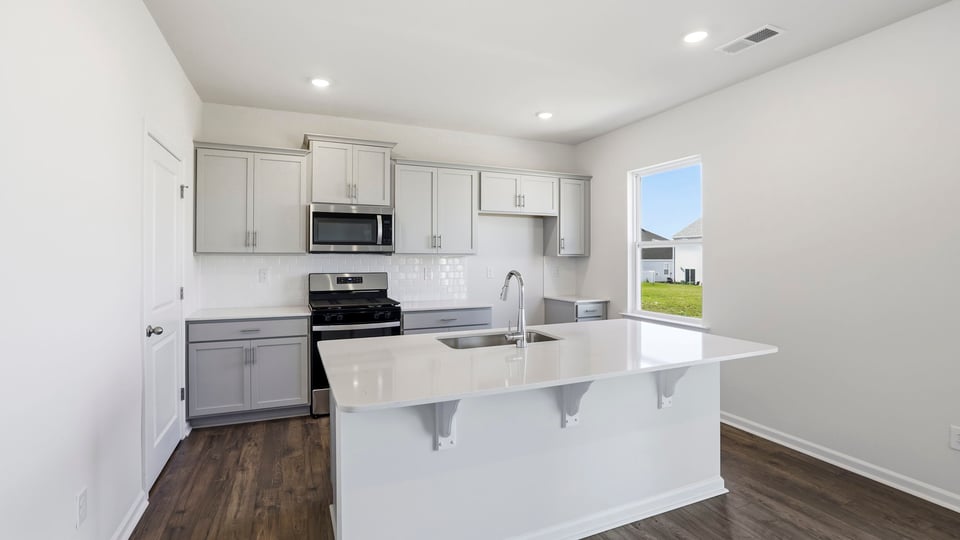 Kitchen with island and cabinets.