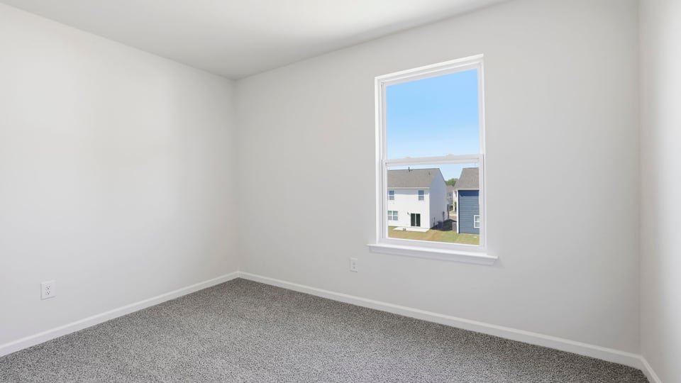 Bedroom with carpet and windows.
