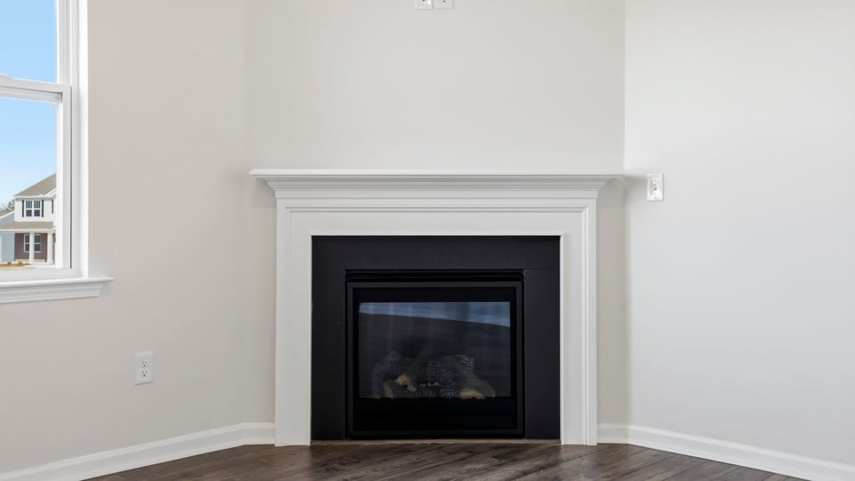 Living room with fireplace and windows.