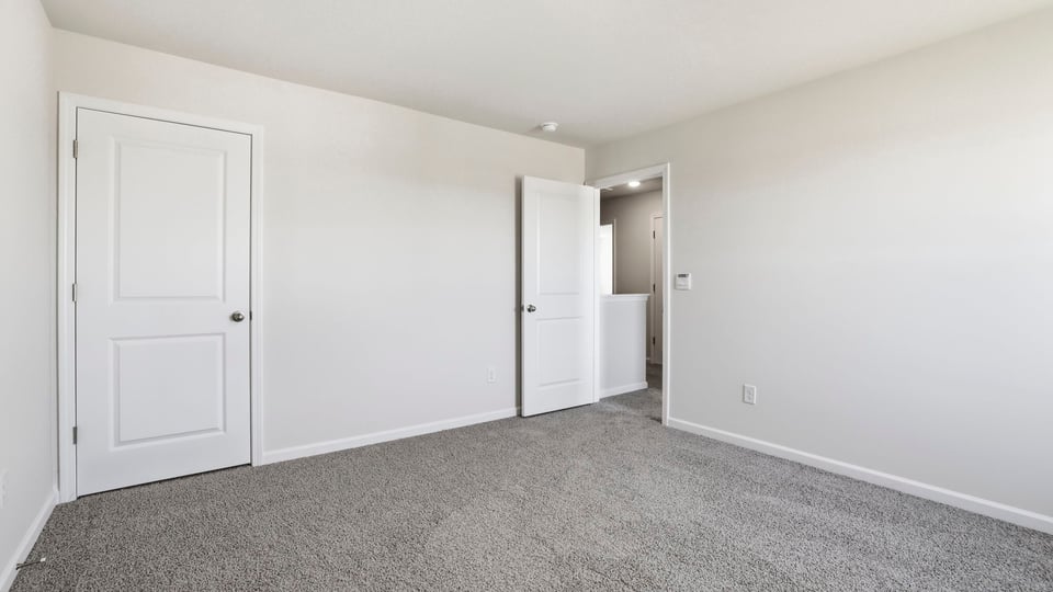 Bedroom with carpet and window.