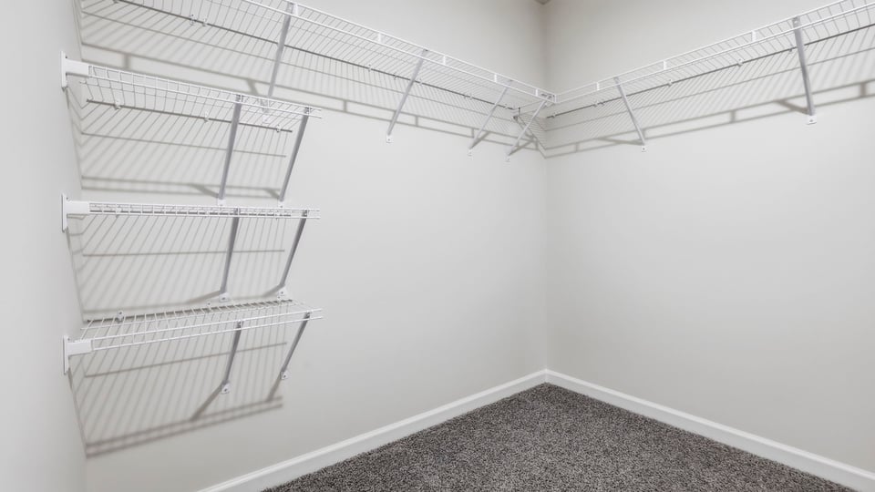 Primary closet with shelf.