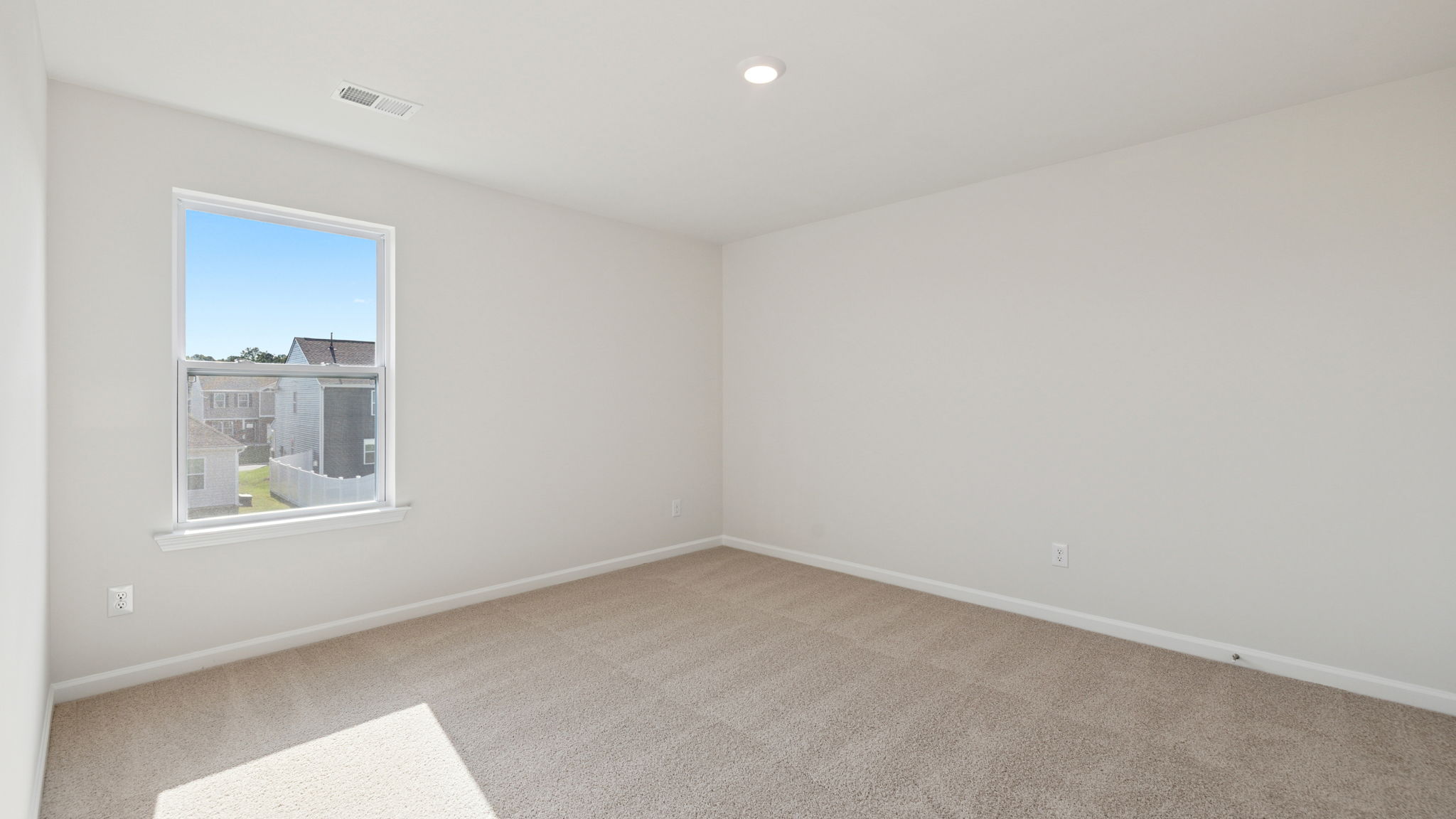 Primary bedroom with carpet.