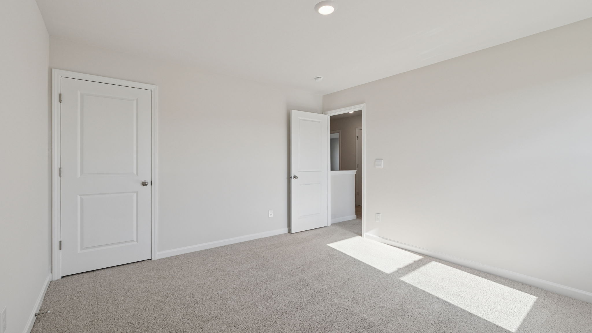 Primary bedroom with carpet.
