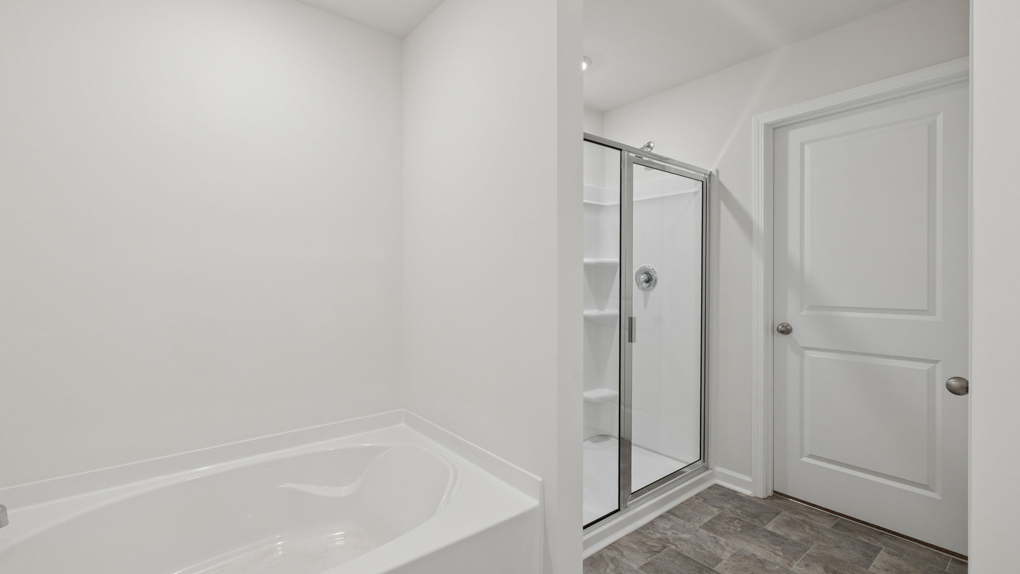Primary bathroom with walk-in shower and optional garden tub.