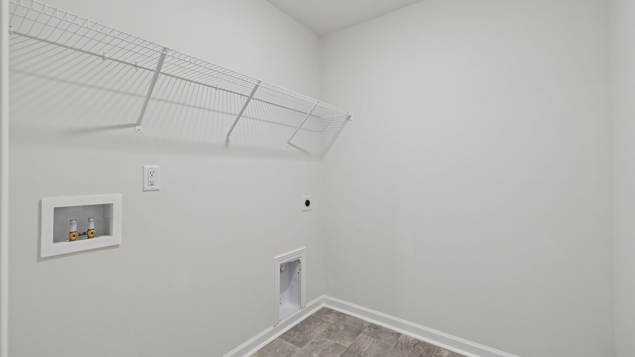 Walk-in laundry room with shelving.