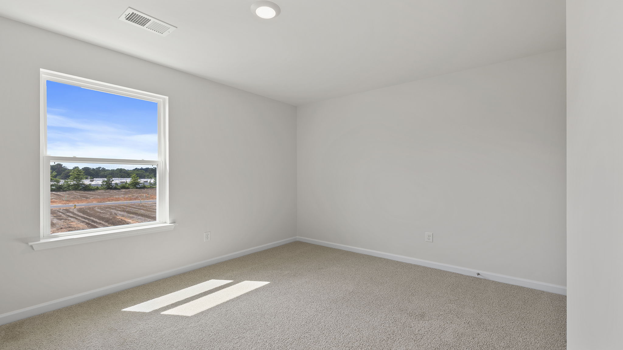 Bedroom with window and carpet.