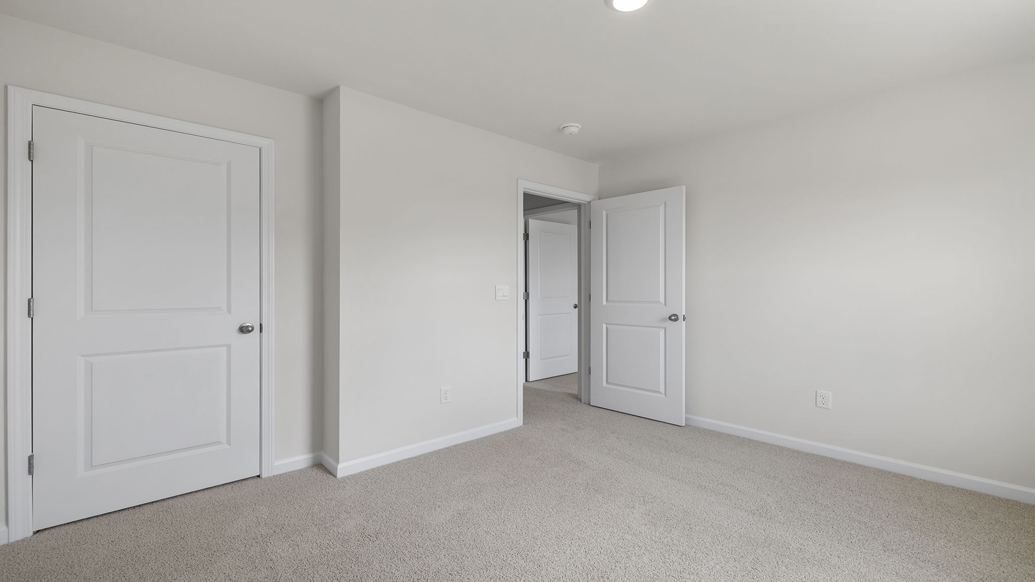 Bedroom with window and carpet.