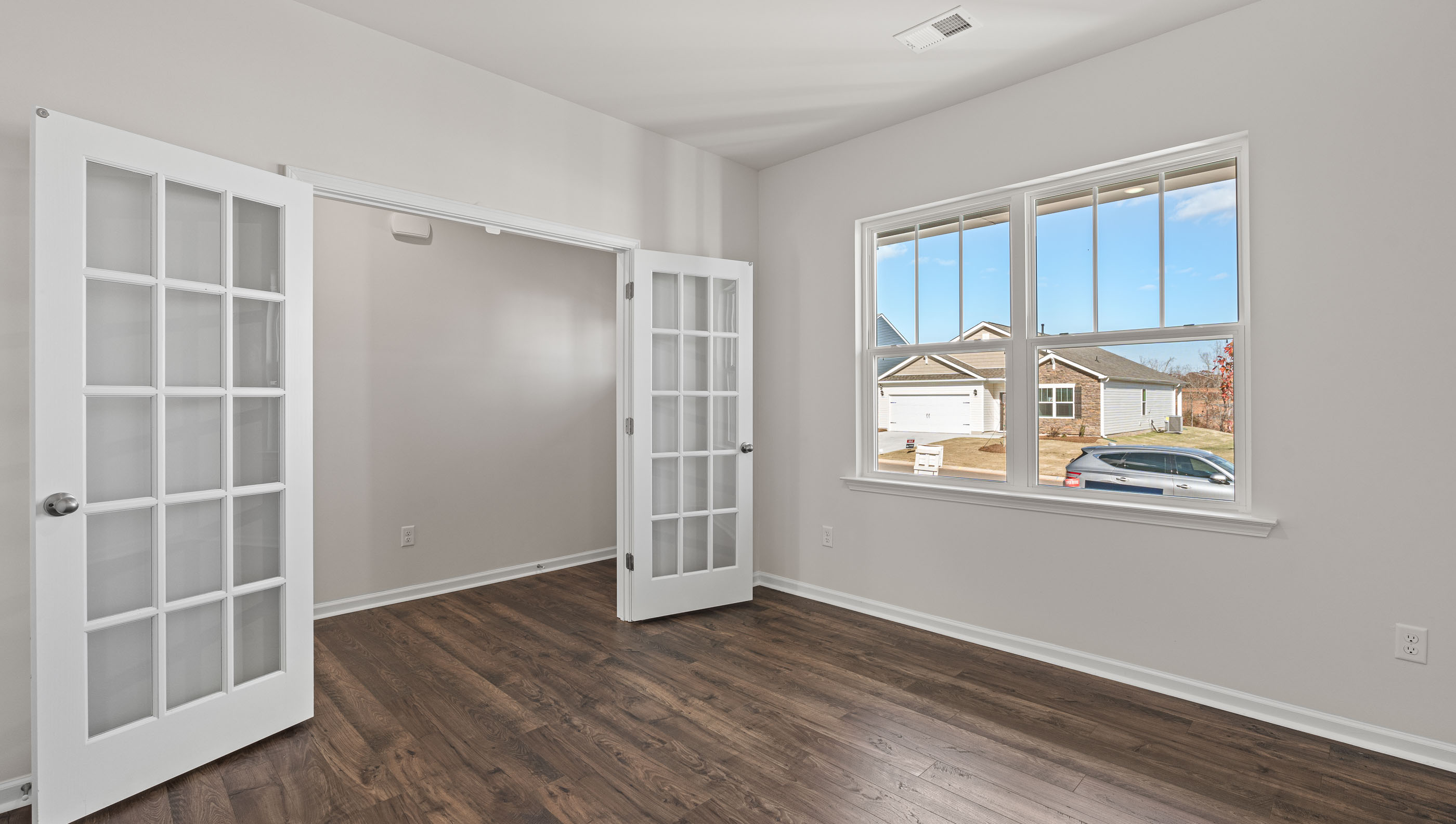 Study accented by French doors.