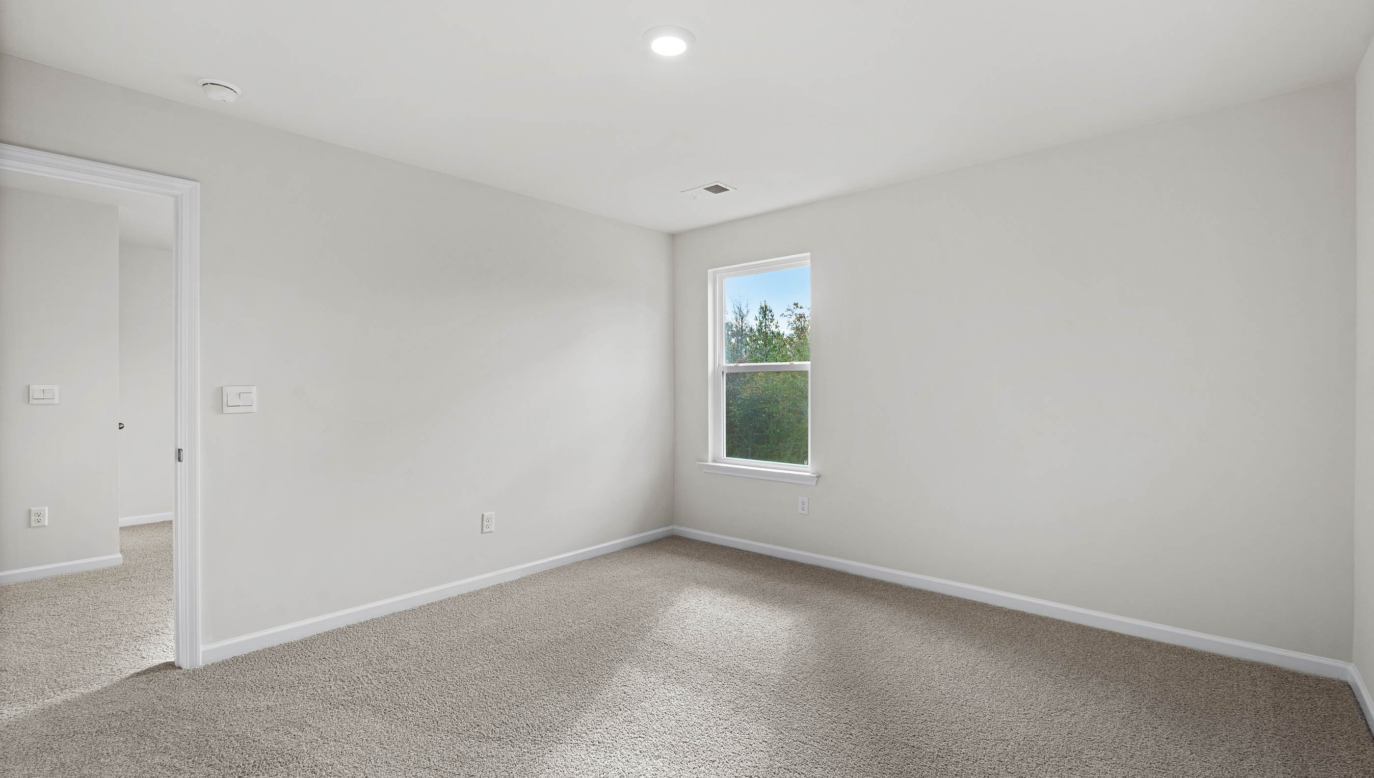 Bedroom with window and carpet.