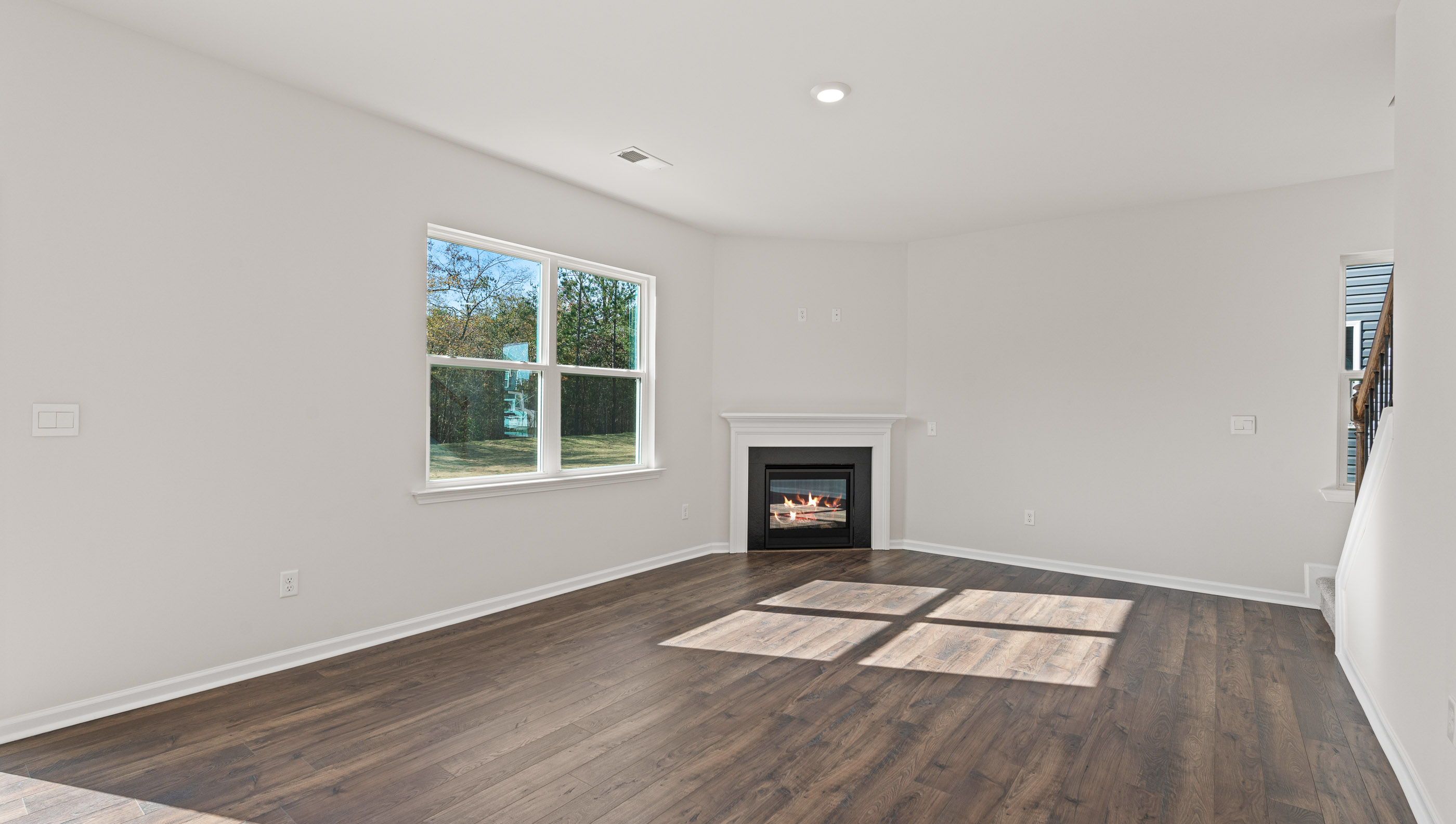 Living area with windows and gas log fireplace.