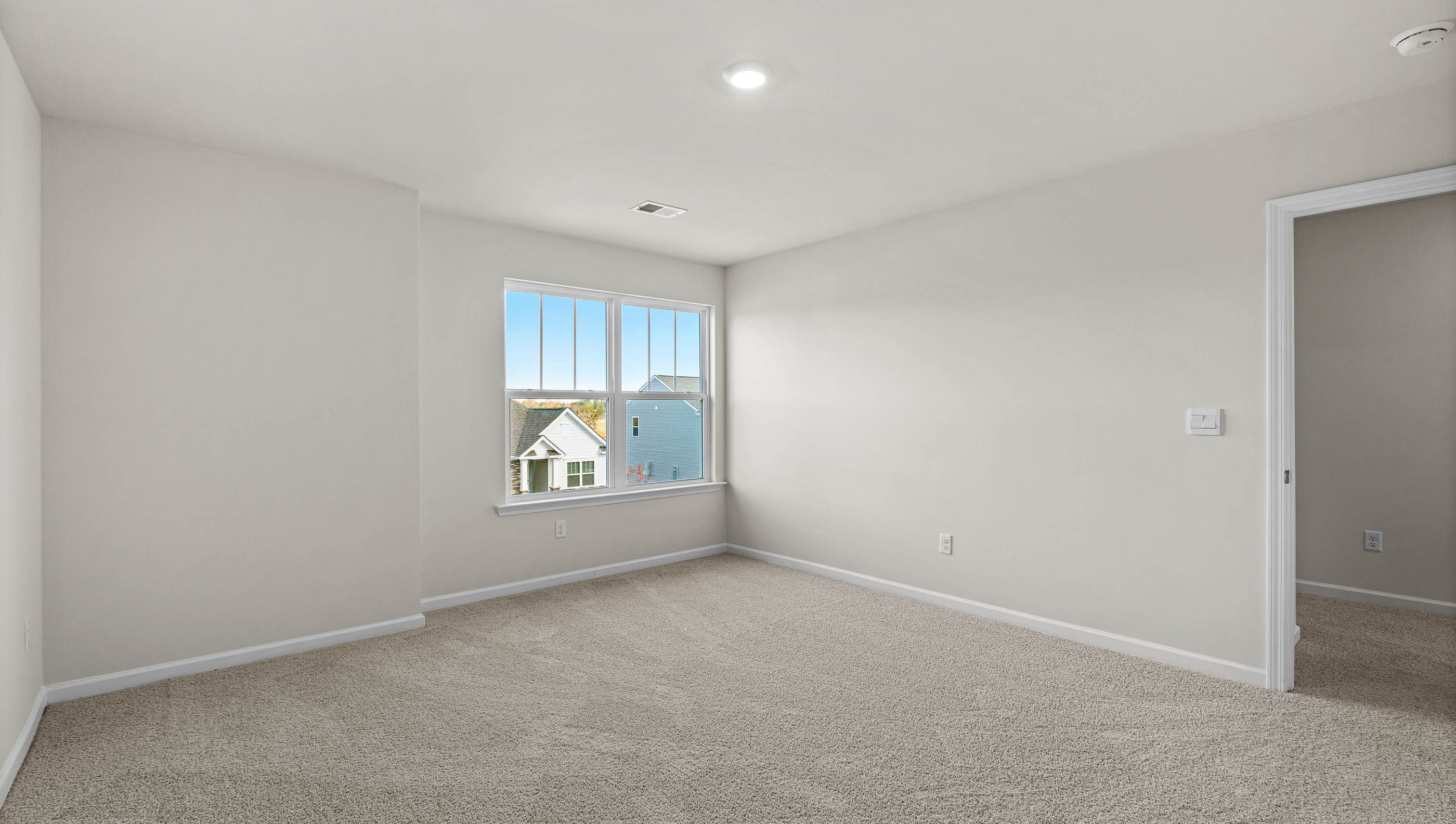 Bedroom with window and carpet.