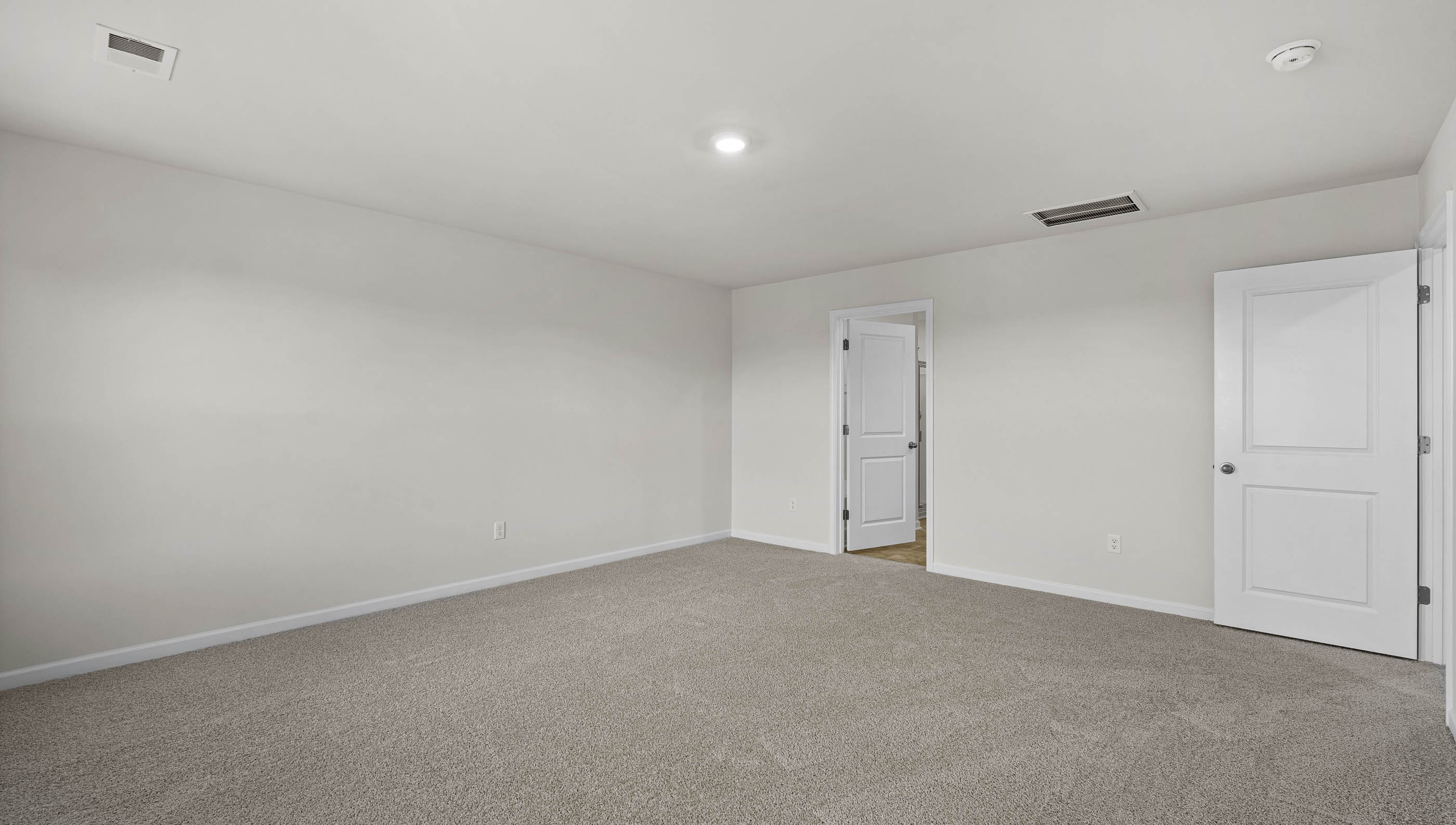 Bedroom with window and carpet.
