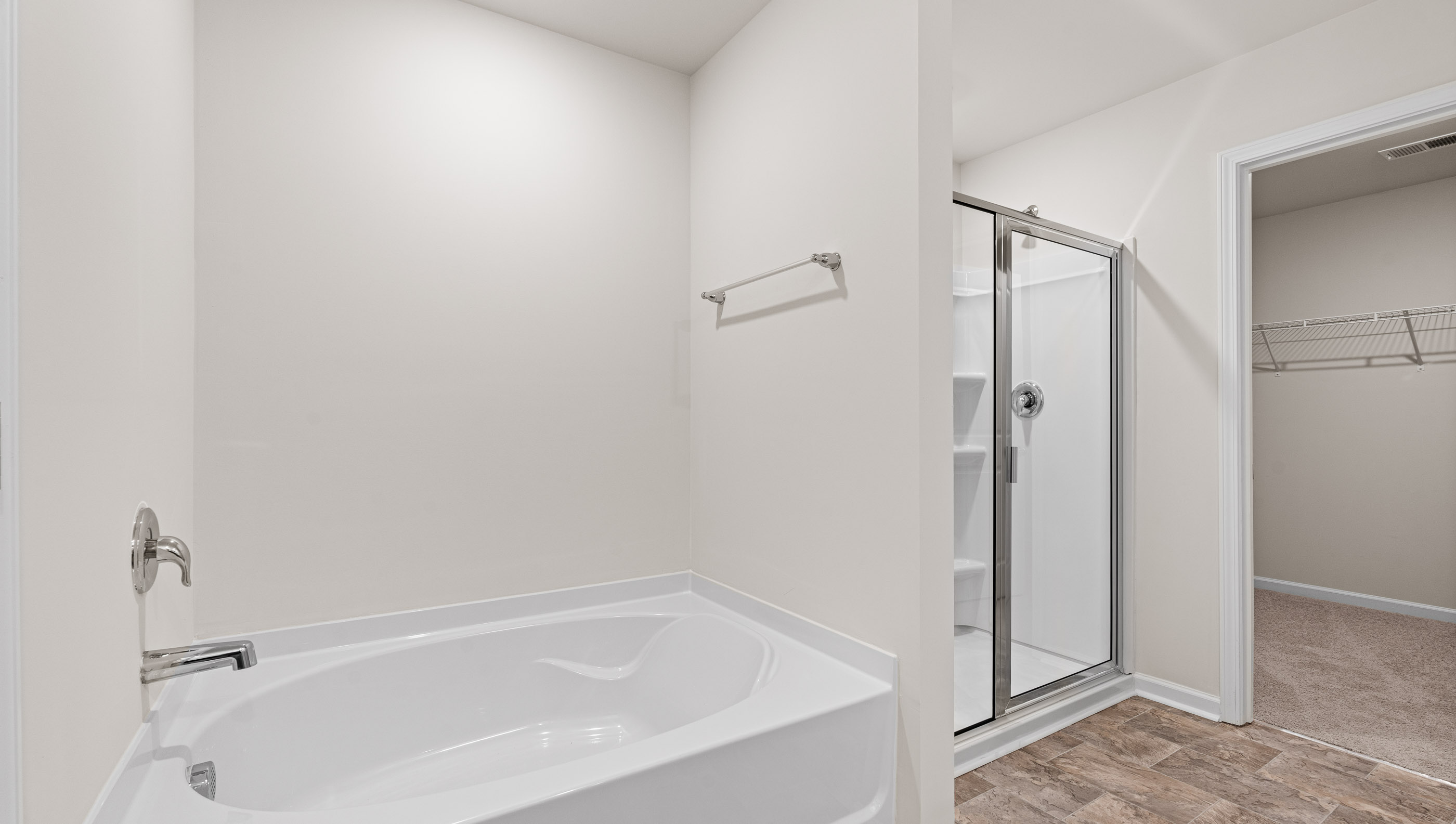 Primary bathroom with garden tub and walk-in shower.