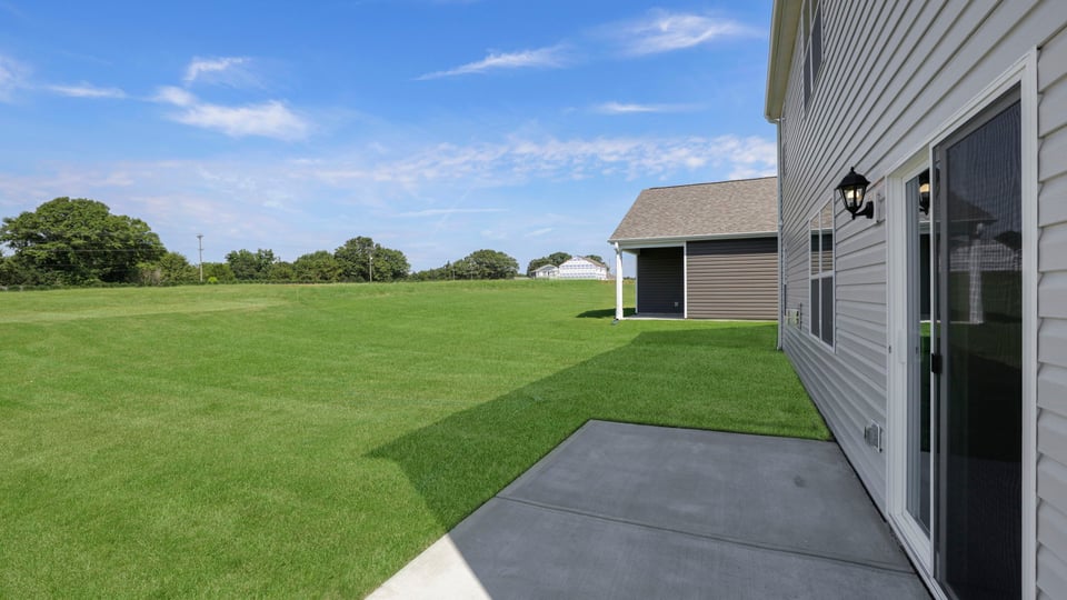 Back exterior with large backyard.