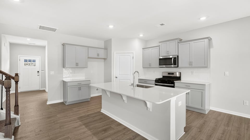 Kitchen and island with quartz countertops.