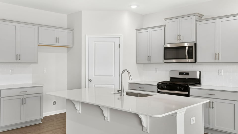 Kitchen and island with quartz countertops.