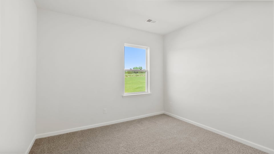 Bedroom with carpet and window.