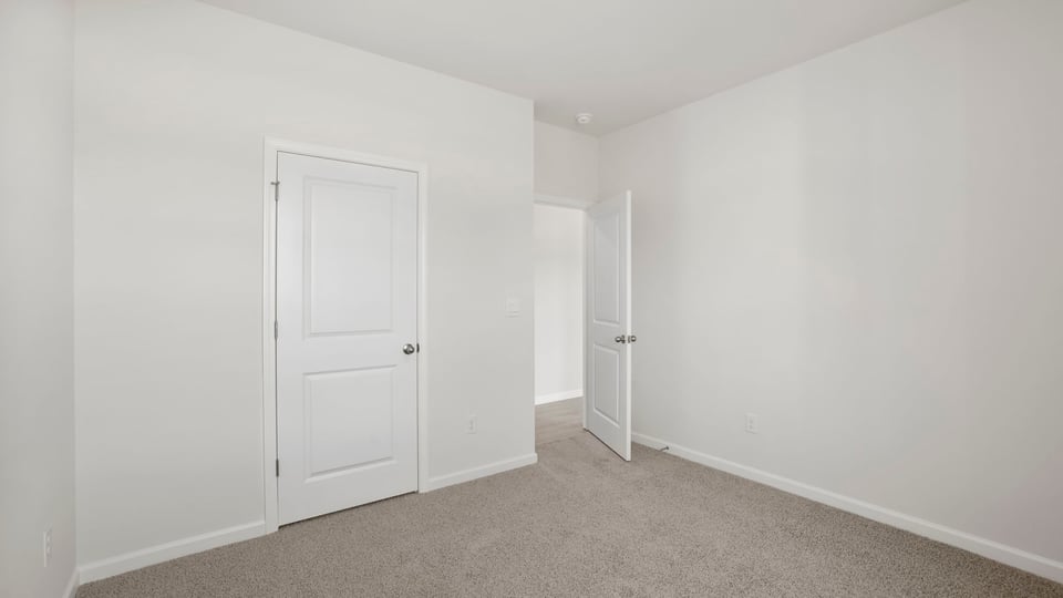 Bedroom with carpet and window.