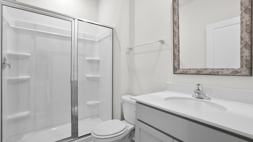 Bathroom with shower and single vanity sink.