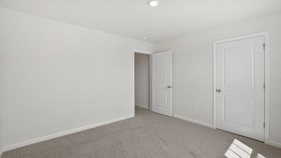 Bedroom with carpet and window.