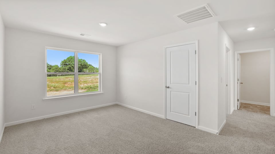 Loft area with carpet and windows.