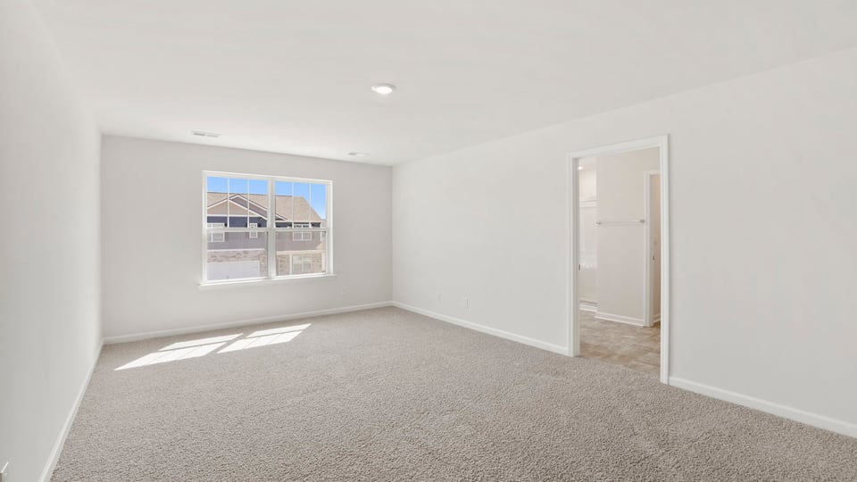 Bedroom with carpet and window.