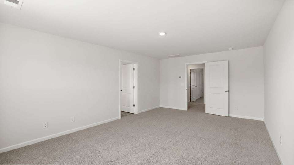 Bedroom with carpet and window.