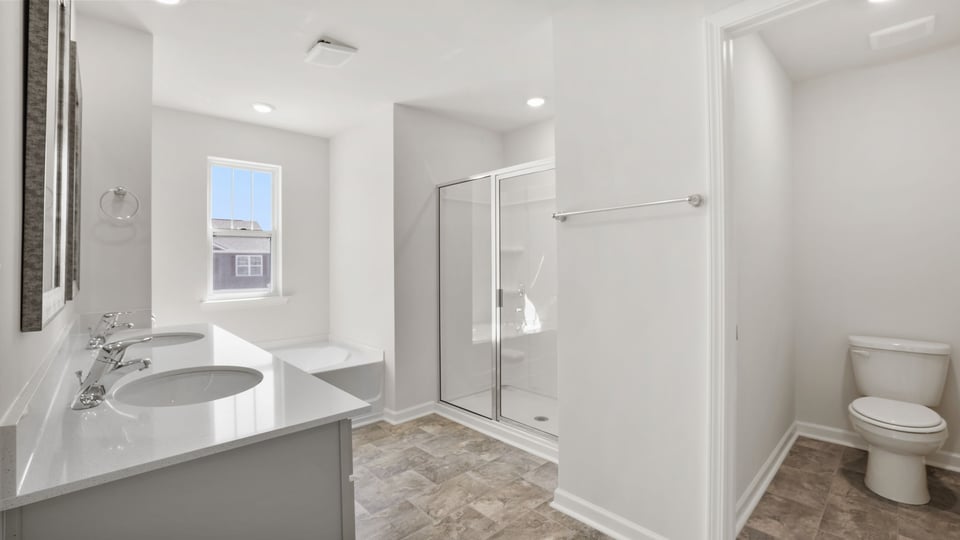 Bathroom with walk in shower and closet.