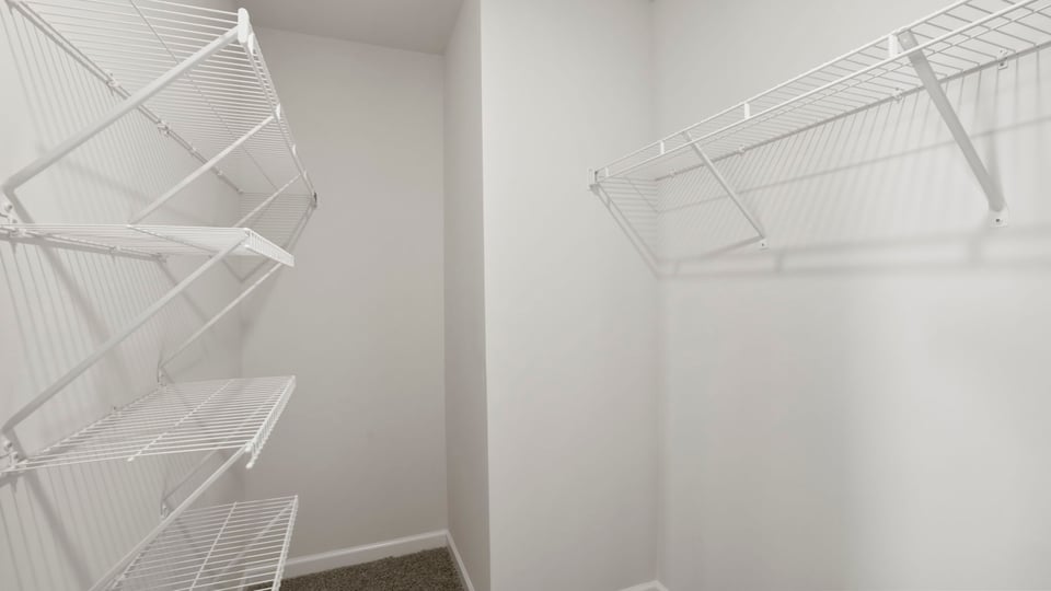 Closet with hanging storage racks.