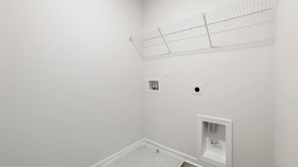 Laundry room with hanging storage racks.