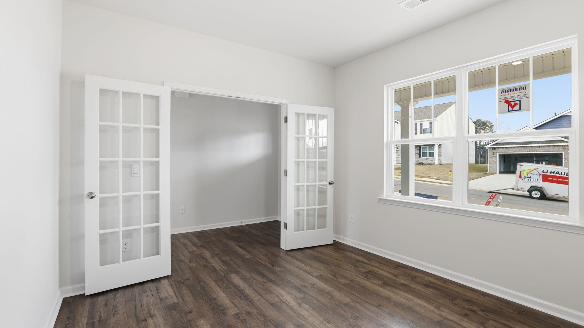 Study with windows and accented by French doors.