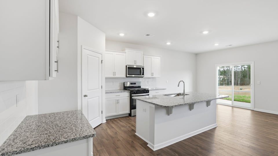 Kitchen and island with quartz countertops.