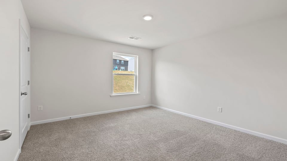 Bedroom with window and carpet.