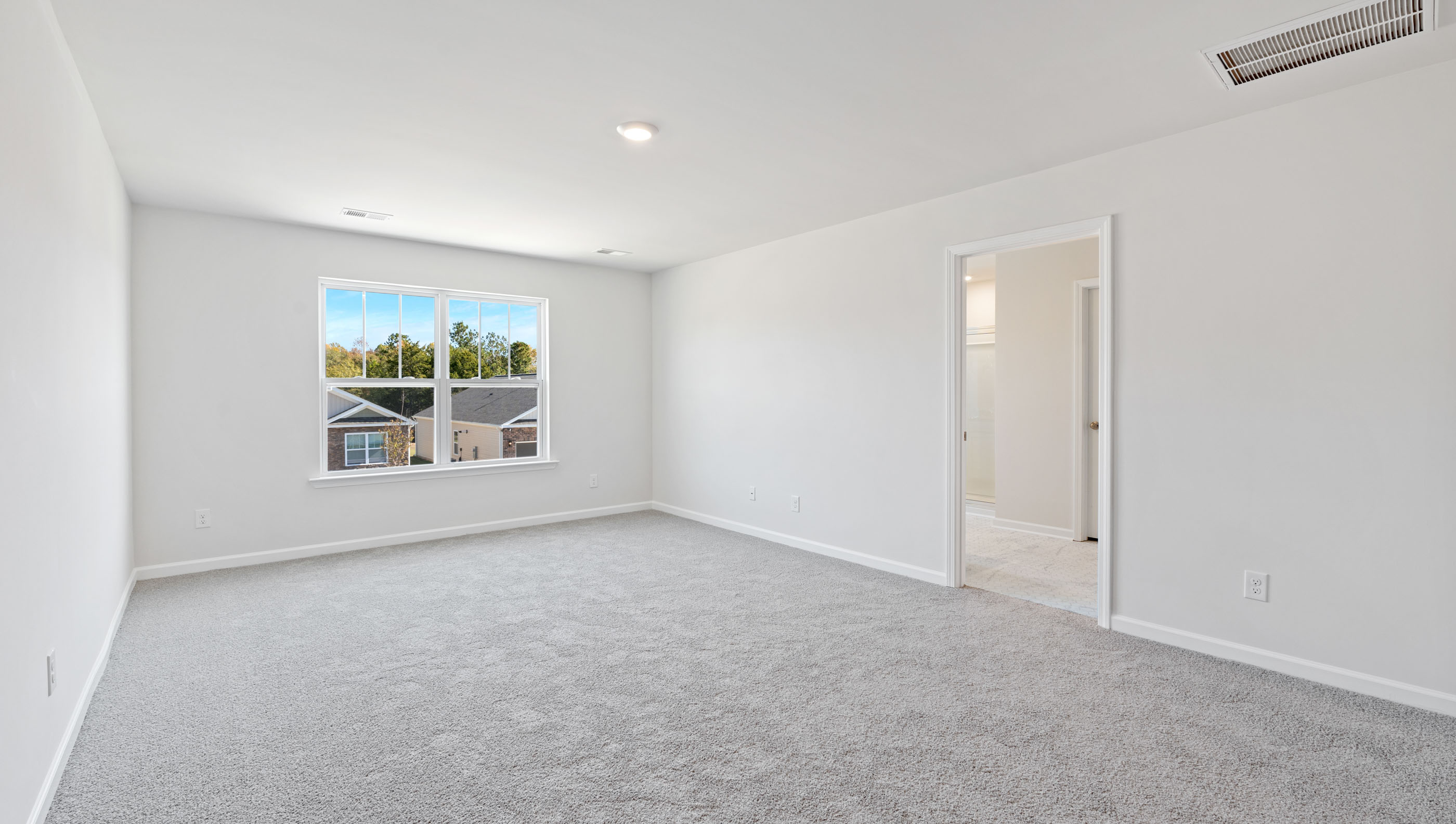 Primary bedroom with large window.