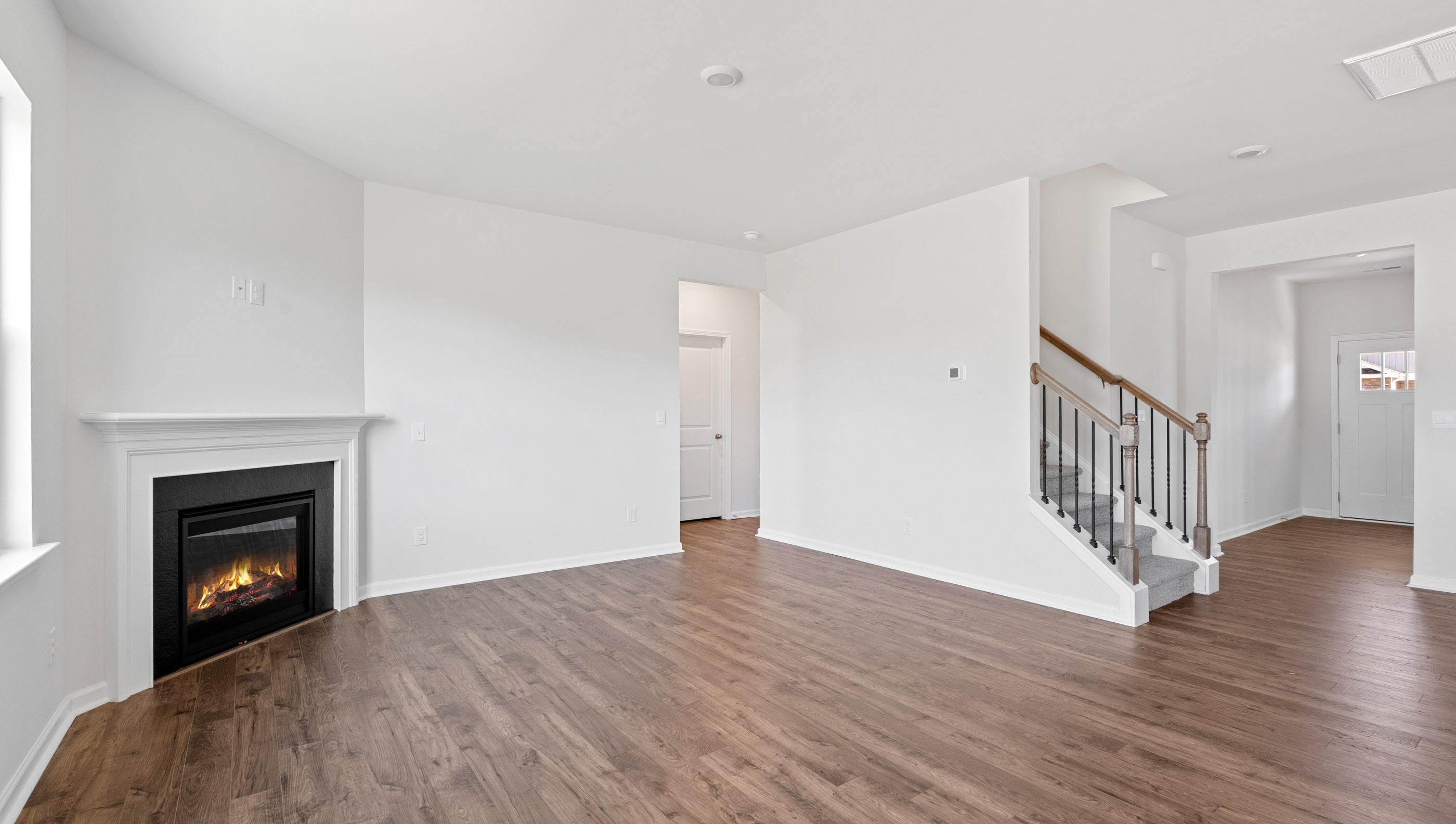View of family room and hallway to entrance.